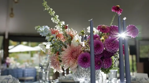 Beautifully arranged wedding table featuring a stunning floral centerpiece with Stock Footage 286272331