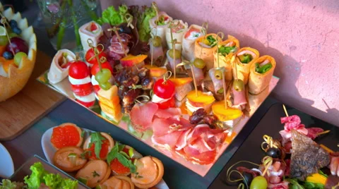 Beautifully decorated buffet table, canapés, rolls, vegetables, fish Stock Footage 65421723