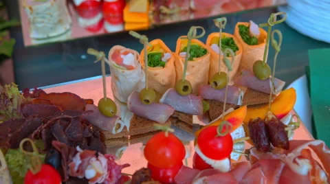 Beautifully decorated buffet table, canapés, rolls, vegetables, fish Stock Footage 65421776