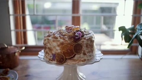 A Beautifully Decorated Cake on an Elegant Cake Stand Stock Footage 299676463