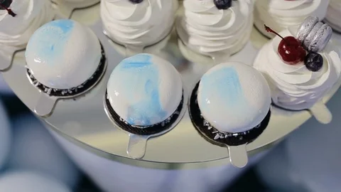Beautifully decorated cupcakes with cherry. Small cakes with on Birthday party Stock Footage 128685656