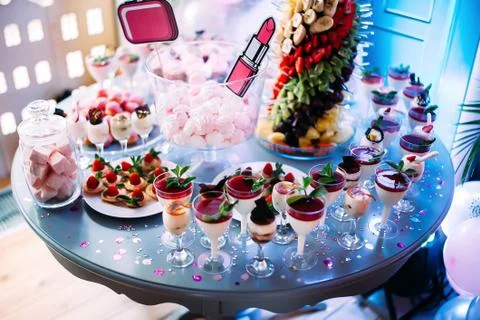 Beautifully decorated table with different cakes and sweets.Ice cream with ja Stock Photos