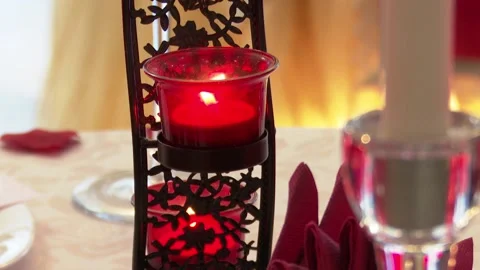Beautifully decorated table for a romantic dinner for lovers, a candle is lit. Stock Footage 123923092