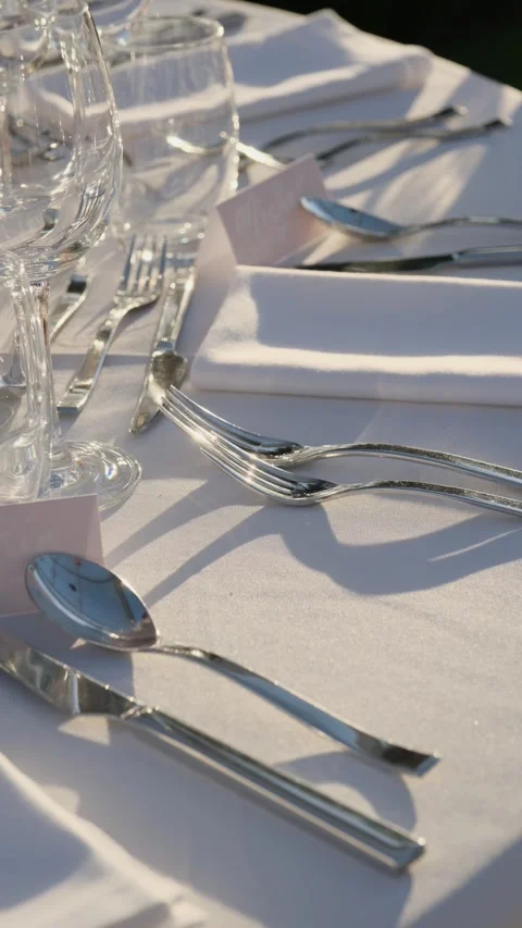 Beautifully decorated table set for an outdoor wedding banquet, with elegant Stock Footage 344007385