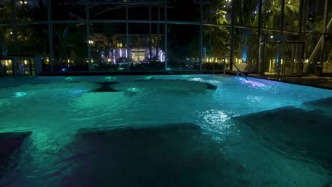 Beautifully lit outdoors pool in a luxury spa resort at night Stock Footage