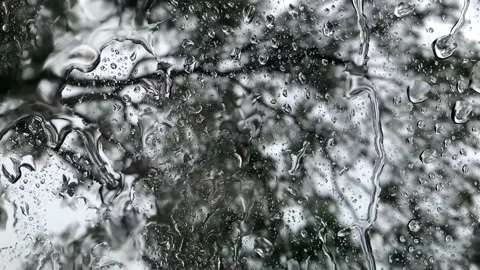 Beautifully raindrops run down the grass. window with rain drops Video stock 139926702