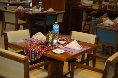 A beautifully set dining table featuring colorful linens &amp; elegant tableware Stock Photos