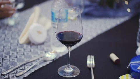 A beautifully set luxury dinner table with fine details before a premium Stock Footage 336288765