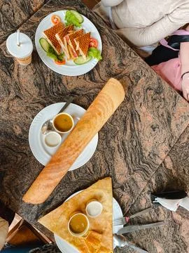 A beautifully set table adorned with an array of delicious plates of food, .. Fotos de archivo