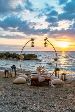 A beautifully set up table on the beach at sunset, Stock Photos