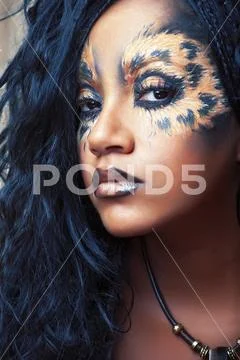 Beauty afro girl with cat make up, creative leopard print closeup, fashion style Stock Photos