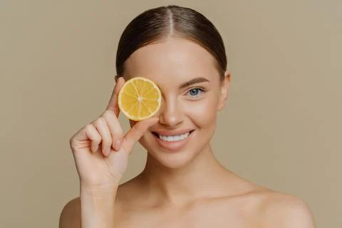 Beauty and vitamin C concept. Headshot of lovely dark haired European woman Stock Photos