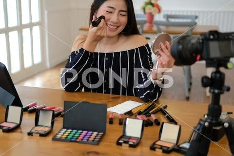 Beauty blogger live broadcasting cosmetic makeup tutorial on social media. Stock Photos