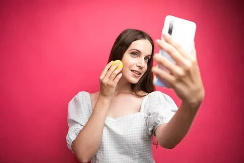 Beauty blogger recording makeup tutorial on pink background Stock Photos