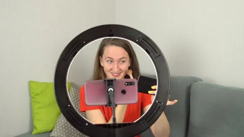 Beauty blogger records makeup tutorial at home while sitting on couch on camera. Stock Footage 151904761