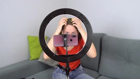 Beauty blogger records makeup tutorial at home while sitting on couch on camera. Stock Footage 151905905