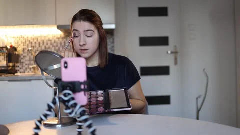 Beauty blogger records makeup tutorial Stock Footage 328042922