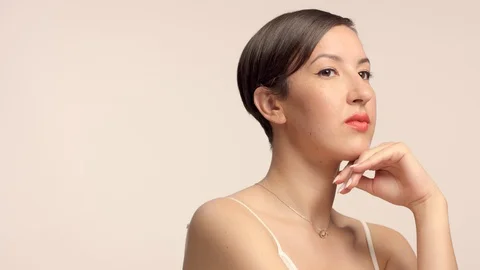 Beauty brunette model in studio alone with ideal shiny skin portrait Stock Footage 112023722