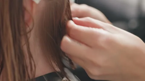 Beauty expert meticulously forming tiny intricate braids, Closeup image Stock Footage 333648716