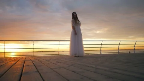 Beauty girl on sky background in a white dress in the sea. beautiful bride Stock Footage