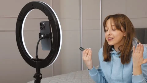 Beauty influencer creating makeup content for social media Stock Footage 314648316