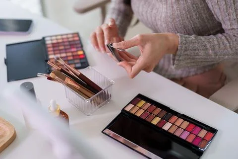 Beauty influencer creating makeup tutorial content using smartphone recordi.. 写真素材