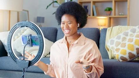 Beauty influencer filming a makeup tutorial at home. Young female blogger live Fotos Stock