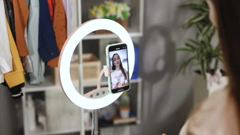 Beauty influencer filming tutorial at home. Young female blogger live streaming Video stock 242571369