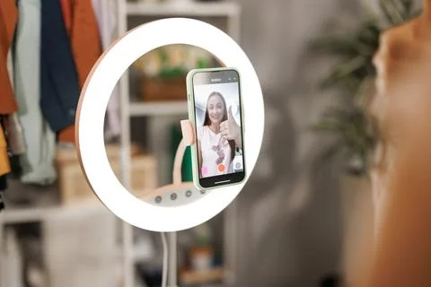 Beauty influencer filming tutorial at home. Female blogger live streaming a Stock Photos
