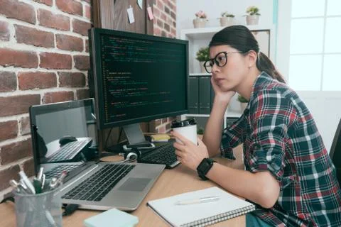 Beauty lady computer worker looking at code data Stock Photos