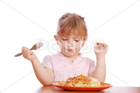 Beauty little girl eat spaghetti.JPG Stock Photos