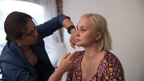 Beauty master applying makeup foundation Stock Footage 255399557