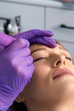 Beauty master performs permanent eyebrow makeup in a beauty salon, microbla.. Stock Photos
