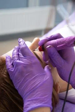 Beauty master performs permanent eyebrow makeup in a beauty salon, microbla.. Stock Photos