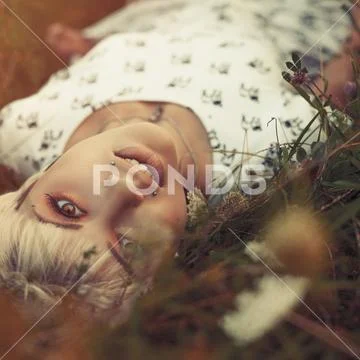 Beauty on the meadow, seasonal female portrait with retro styled colorization Stock Photos