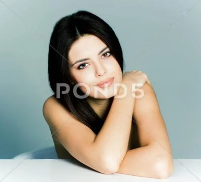 Beauty portrait of a young female model on gray background Stock Photos