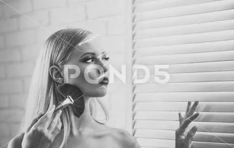 Beauty portrait of young woman with the makeup brush Stock Photos