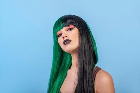 Beauty portrait of young woman wearing half black green color wig, dark lips Stock Photos