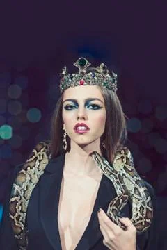 Beauty queen hold python. Sensual woman with snake. Woman with makeup face and 스톡 사진
