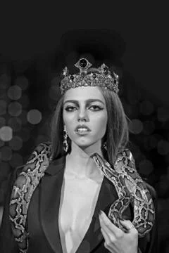 Beauty queen hold python. Sensual woman with snake. Woman with makeup face and 写真素材