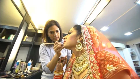 Beauty Salon Master doing makeup and applying red lipstick to beautiful Stock Footage 111379285