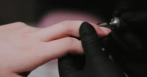 In the beauty studio, the master does hardware manicure. Removing gel polish wit Stock Footage 149366541