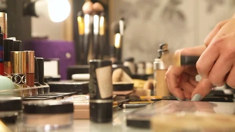 Beauty stylist organizing makeup table Stock Footage