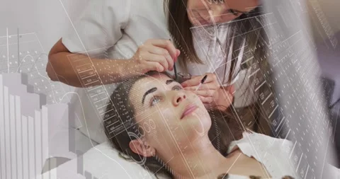 Beauty technician using brush combing brow and plucking hairs with data overlay Vídeos de archivo 326191168