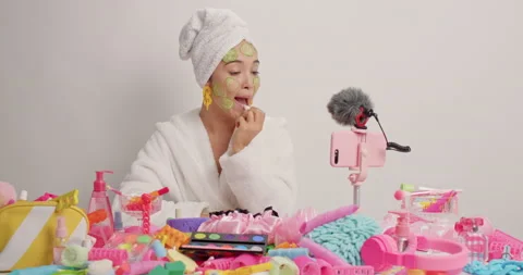 Beauty vlogger records tutorial video applies lipstick beauty mask with Stock Footage 156226017