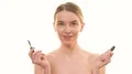 The beauty woman applying a mascara on the white background 4k or 4k+ Resolution