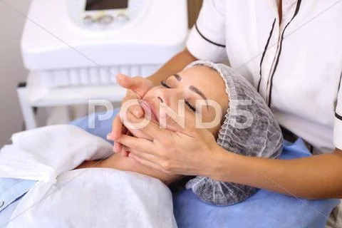 Beauty woman having cosmetic massage Stock Photos