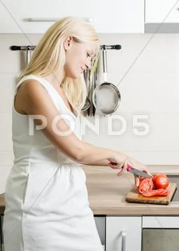 Beauty woman in the kitchen Stock Photos