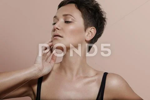 Beauty woman with a short haircut. ideal skin beige background Stock Photos
