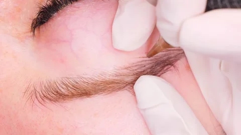 Beauty worker replicates natural eyebrow hairs using special machine Stock-Footage 277441443